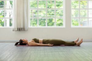 Asian woman practice yoga Dead Body or Savasana pose with meditation smile at home Feeling so comfortable and relax,Healthcare Concept