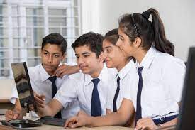 A GROUP OF STUDENTS STUDYING ON A COMPUTER