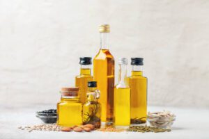 Various vegetable and nut oil in bottles on a bright background. cooking mistakes